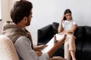 Mental health therapist holding notes during a counseling session with a client for mental health support in Nagpur.